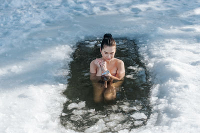 Shirtless man swimming in sea