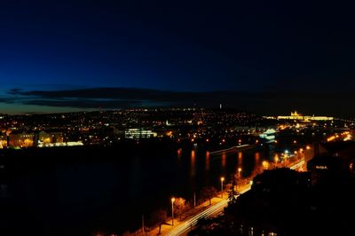 Illuminated cityscape against sky at night