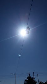 Low angle view of electricity pylon against clear sky