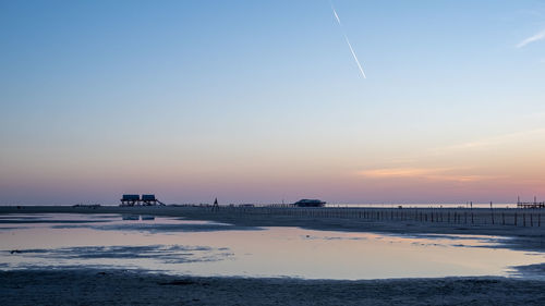 Scenic view of beach against sky during sunset