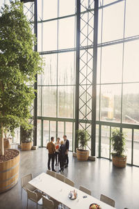 High angle view of multi-ethnic business people discussing in creative office