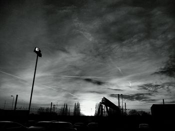 Low angle view of street light against cloudy sky