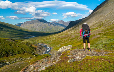 Rear view of man walking on mountain