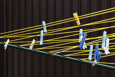 Low angle view of metal railing against blue fence