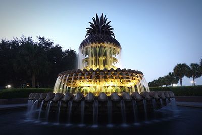 Fountain in park against clear sky