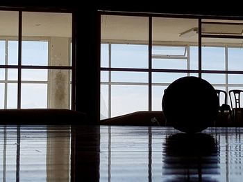 Silhouette of building seen through window