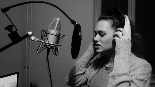 Woman singing in recording studio