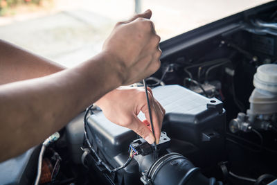 Auto mechanic checking car engine,worker selective focus