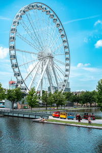 Low angle view of ferris wheel against sky