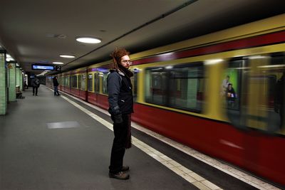 Rear view of man walking in subway