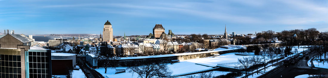 Buildings against cloudy sky during winter