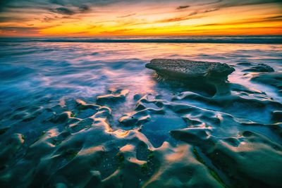 Close-up of sea against sky during sunset