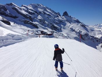 Rear view of a person skiing