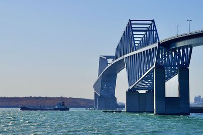 Bridge over sea against clear sky