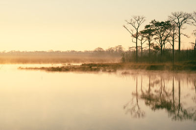 Scenic view of lake against sky during sunset