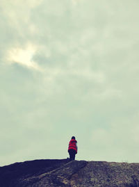 Rear view of woman standing against sky