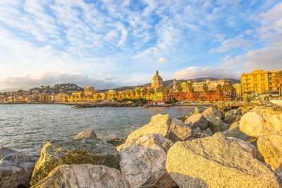 View of sea and buildings against sky