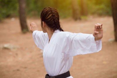 Side view of young woman standing outdoors