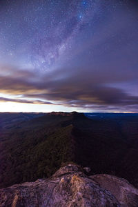 Scenic view of land against sky at night