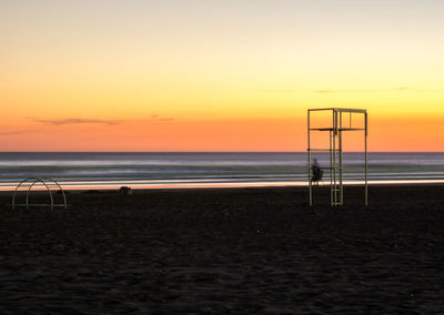 Scenic view of beach against sky during sunset