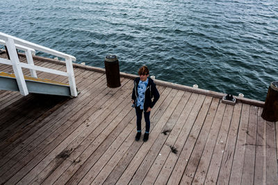 High angle view of teenager standing at busselton jetty