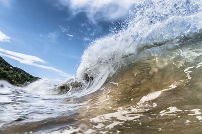 Water splashing in sea against sky