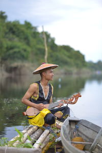 Woman sitting in boat on lake