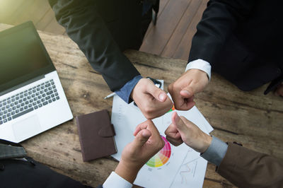 High angle view of people working on table