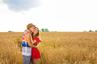 Woman standing on field against sky