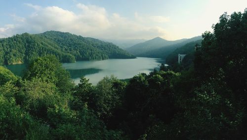 Scenic view of lake and mountains against sky