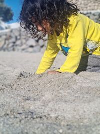 Child playing on the beach in the sand