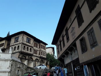 Low angle view of buildings against clear blue sky