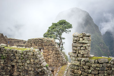 Stack of stone building against cloudy sky machu picchu peru