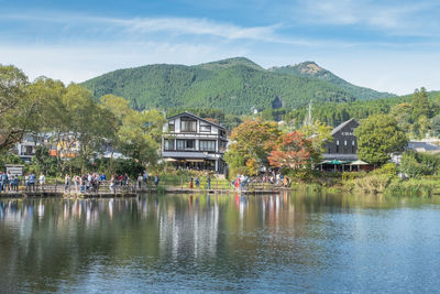 Scenic view of lake by buildings against sky