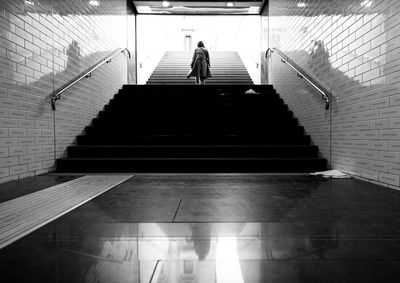 Low angle view of person walking on staircase