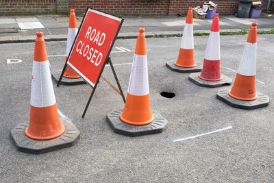 Close-up of arrow sign on road