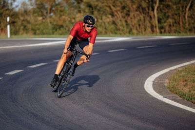 Man riding bicycle on road