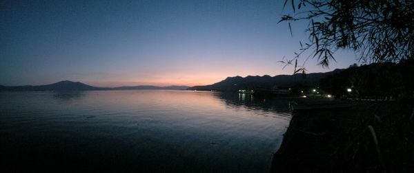 Scenic view of sea against clear sky at sunset