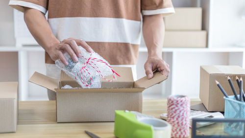 Midsection of woman holding gift