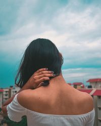 Rear view of woman in sea against sky