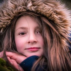 Close-up portrait of a girl in snow