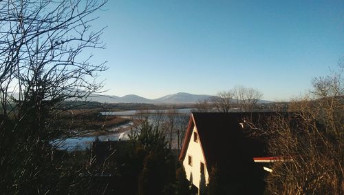 Scenic view of mountains against clear blue sky