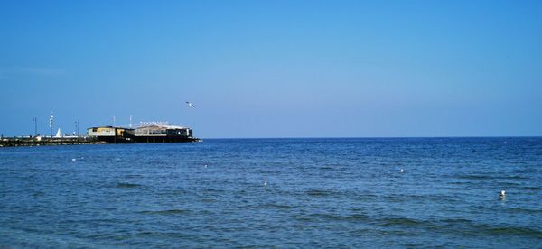 Scenic view of sea against clear blue sky