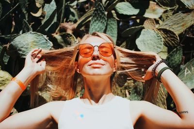 Young woman wearing sunglasses while standing outdoors