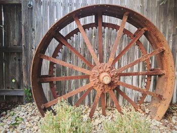 Old abandoned wheel against wall