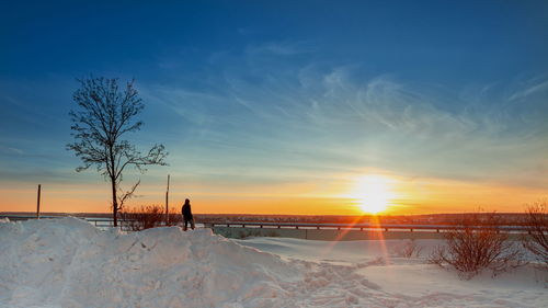 Scenic view of snow field against sky during sunset