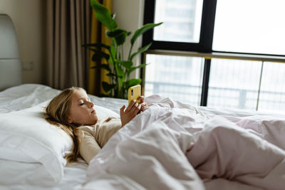 Young woman sleeping on bed at home