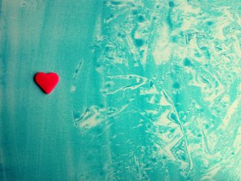 Close-up of red heart shape decoration on textile