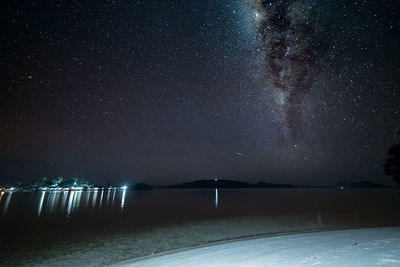 Scenic view of star field over lake