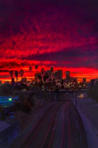 High angle view of illuminated railroad tracks against sky during sunset